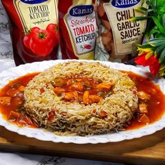 A picture of Chicken Manchurian with fried rice.