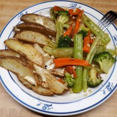 A picture of Wedged potato jackets served with veges.