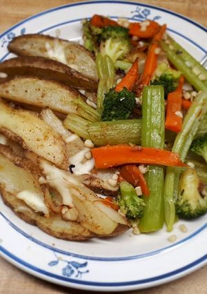 A picture of Wedged potato jackets served with veges.