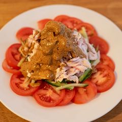 A picture of Bang Bang Chicken: Chinese chicken dish with a sesame sauce.