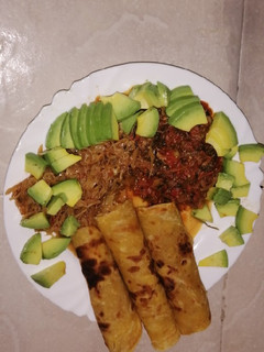 A picture of Traditional matumbo stew, served with chapati and cabbage.
