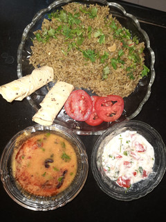 A picture of Spinach rice with dal fry and curd salad.