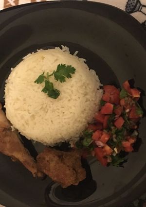 A picture of Boiled Rice,pan fried Mar inated chicken and kachumbari.