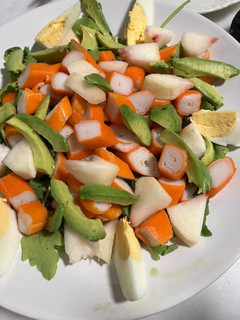 Una foto de Ensalada de rúcula, surimi, paraguaya, aguacate y huevo