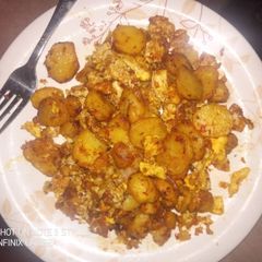A picture of Fried potatoes with eggs.