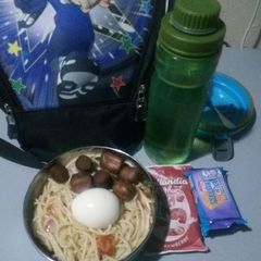 A picture of Pasta with boiled egg and fried sausage.