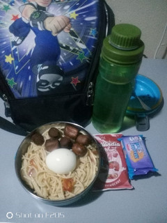 A picture of Pasta with boiled egg and fried sausage.