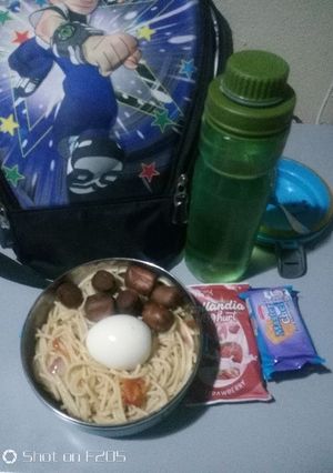 A picture of Pasta with boiled egg and fried sausage.