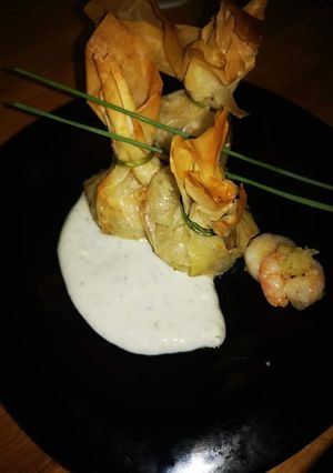 A picture of Shrimp Phyllo Pouches with Blue Cheese Sauce.
