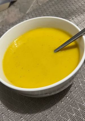 A picture of Zucchini and Carrot Soup with Creamy Cheese.