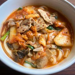 A picture of Fiery Pork & Kimchi Udon Soup.