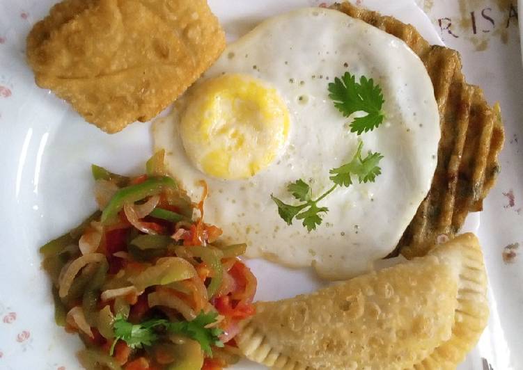 Poached eggs,samosa,hash browns and kachumbari