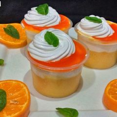 A picture of Cream Custard shots with orange sauce.