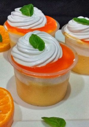 A picture of Cream Custard shots with orange sauce.