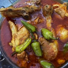 Chicken karahi (red dish) A picture of Chicken karahi (red dish).