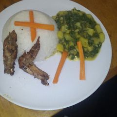 A picture of White rice with creamed potatoes spinach and pan fried chicken.