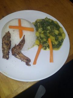 A picture of White rice with creamed potatoes spinach and pan fried chicken.
