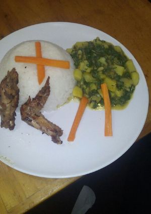 A picture of White rice with creamed potatoes spinach and pan fried chicken.