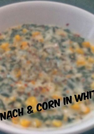 A picture of Spinach and Corn on white Sauce.