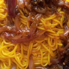 A picture of Tumeric pasta with onion sauce.