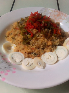 A picture of Steamed Rice Grits (Dambun Shinkafa) with Pepper and Onion Sauce.