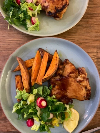 Recipe Sticky bbq chicken thighs served with sweet potato chips and a crisp lemon salad the Delicious Tasty