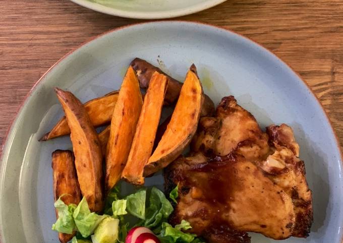 Sticky bbq chicken thighs served with sweet potato chips and a crisp lemon salad