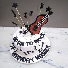 Birthday cake music theme top on fondant guitar 🎸🎸🎸 A picture of Birthday cake music theme top on fondant guitar 🎸🎸🎸.
