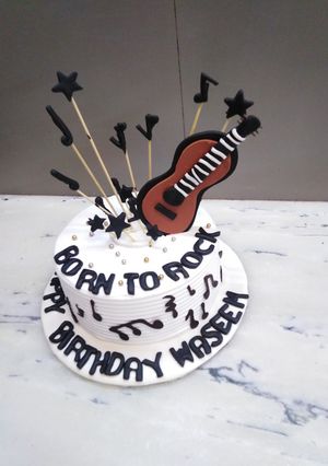 A picture of Birthday cake music theme top on fondant guitar 🎸🎸🎸.