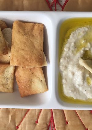 A picture of Baba Ganoush with pita chips.