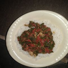 A picture of White rice with spinach sauce.