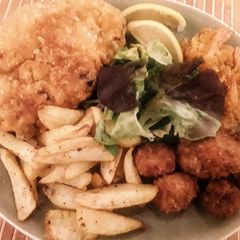 A picture of Breaded pork chop, shrimp and mushrooms.