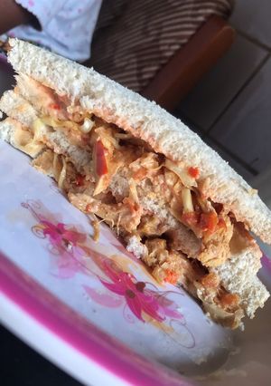 A picture of Chicken and veggies sandwich.