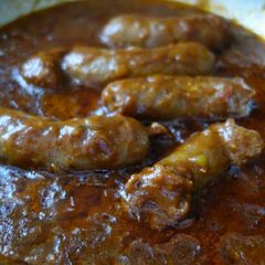 A picture of Sausages with Tomato gravy.