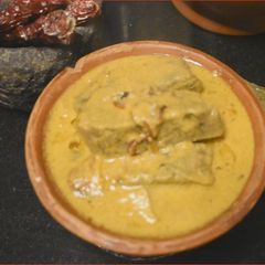 A picture of Pathrade Colocasia Rolls in coconut gravy with Mutton Chicken.