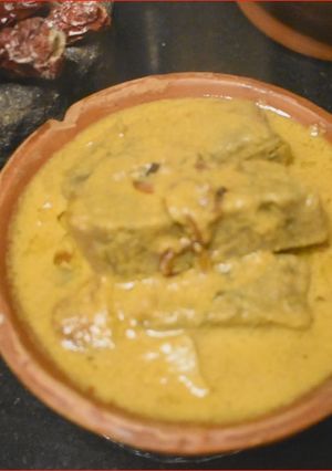A picture of Pathrade Colocasia Rolls in coconut gravy with Mutton Chicken.