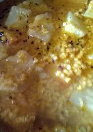 A picture of Red lentil with gourd and pumpkin slices.