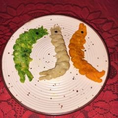 Tri colour shrimp shape pitha A picture of Tri colour shrimp shape pitha.