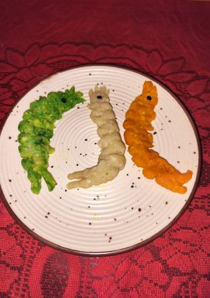 A picture of Tri color shrimp shape pitha.
