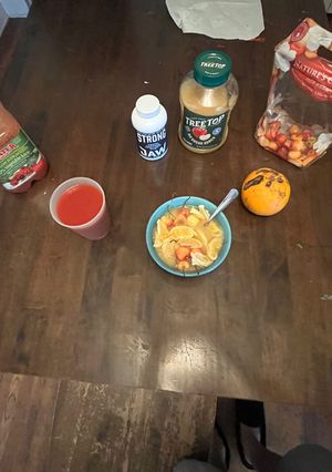 A picture of Fruit Bowl with Tomato Drink.
