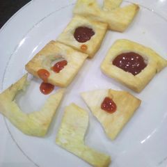 A picture of Fried yam wit ketchup.