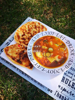 A picture of Vegetable soup with Naan bread.