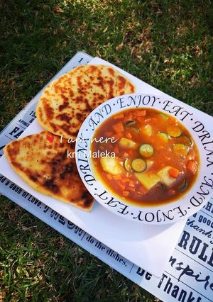 A picture of Vegetable soup with Naan bread.