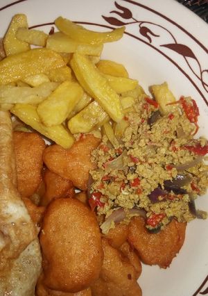 A picture of Egg source, chips, akara n fried egg.