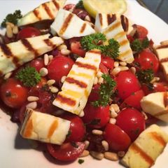 A picture of Grilled Halloumi, Tomato & Olive Salad.
