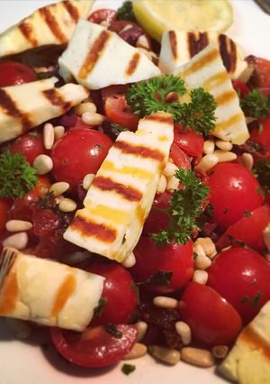 A picture of Grilled Halloumi, Tomato & Olive Salad.