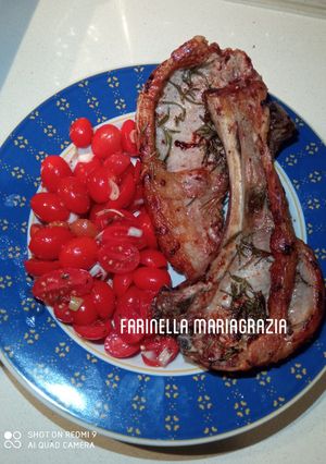 A picture of Pork Ribs with Cherry Tomatoes in an Air Fryer.