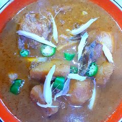A picture of Aloo chicken qorma curry.