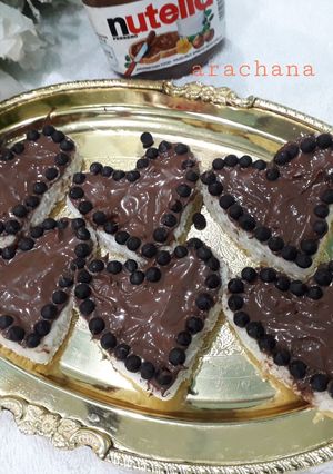 A picture of Nutella top on bread with choco chips.