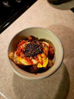 A picture of Curry Potatoes & Eggs with Sriracha.